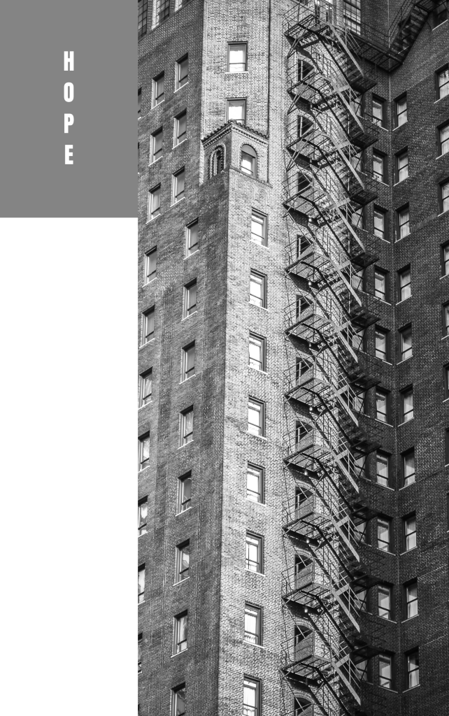 Photo of vintage, high-rise apartment building in black and white with the word "hope" along the side.